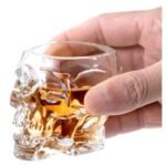 Crystal skull shot glass filled with whiskey or liquor for home bar decor